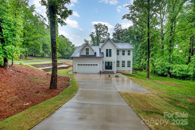10221 Hanging Moss Trl, Mint Hill, NC 28227 - view of front of house featuring board and batten siding, concrete driveway, a front lawn, and a shingled roof