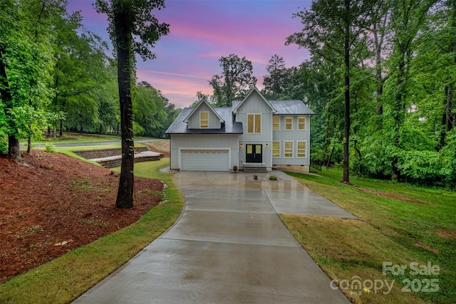 10221 Hanging Moss Trl, Mint Hill, NC 28227 - view of front of house with board and batten siding, concrete driveway, a front lawn, and a garage