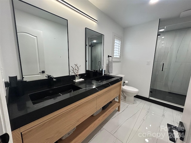 bathroom featuring a shower with door, vanity, and toilet