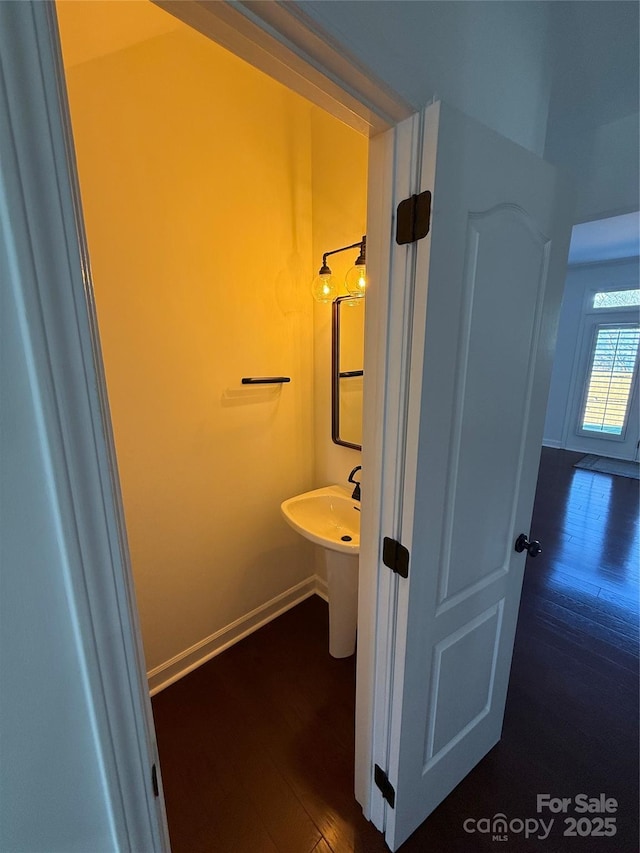 bathroom with wood finished floors and baseboards