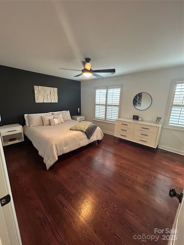 bedroom featuring dark wood-type flooring, ceiling fan, and baseboards