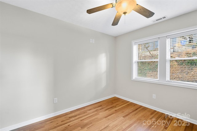 spare room featuring ceiling fan and light wood-type flooring