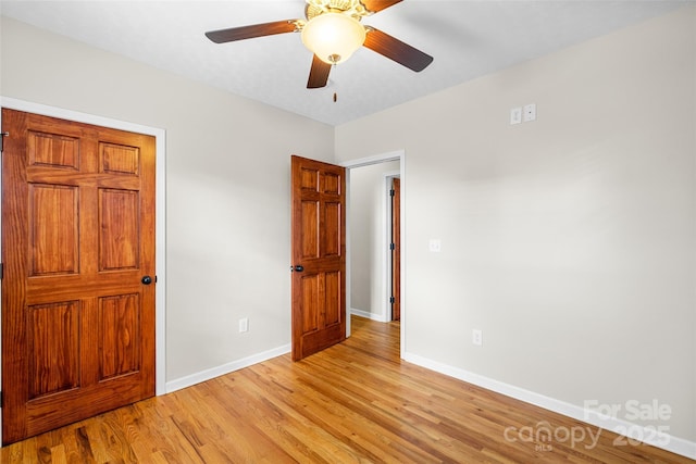 unfurnished bedroom with ceiling fan and light hardwood / wood-style flooring