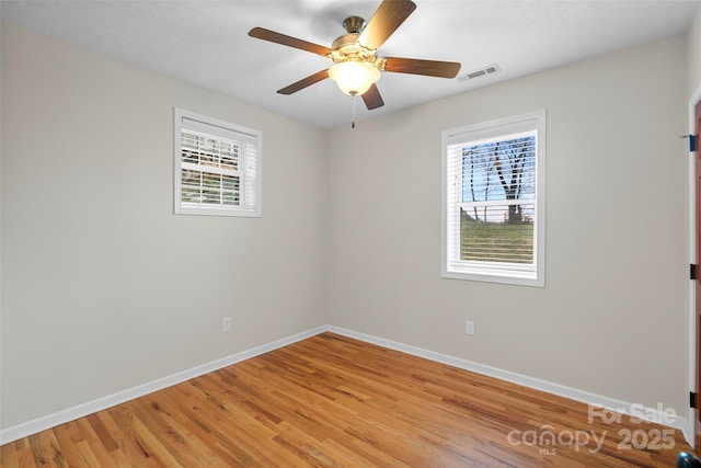 empty room featuring ceiling fan and light hardwood / wood-style floors