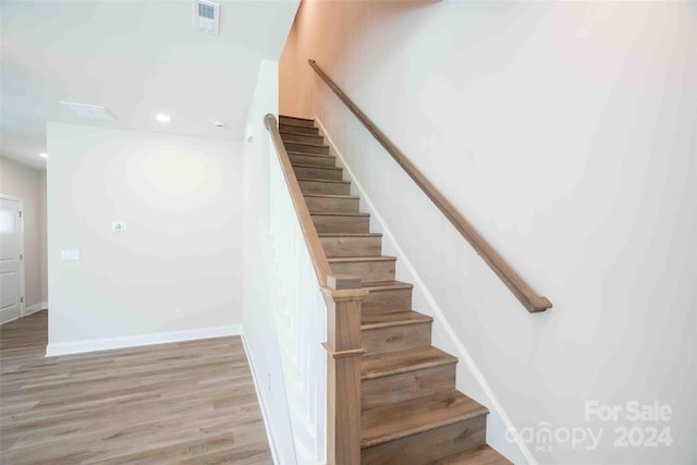 stairway featuring hardwood / wood-style flooring