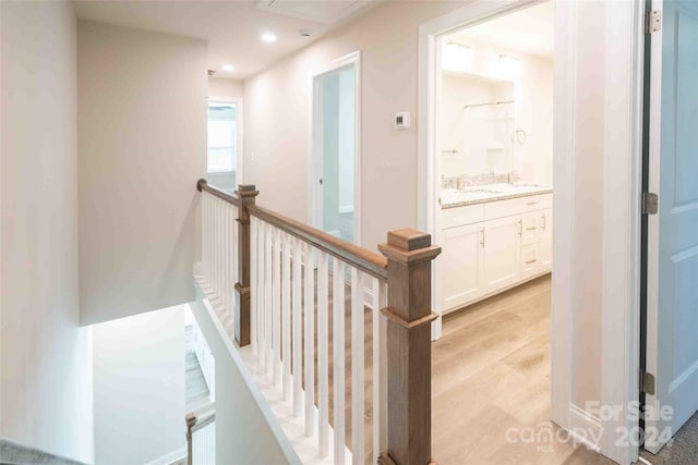 hallway featuring light hardwood / wood-style floors and sink