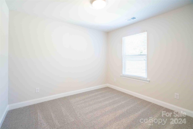 unfurnished room featuring carpet