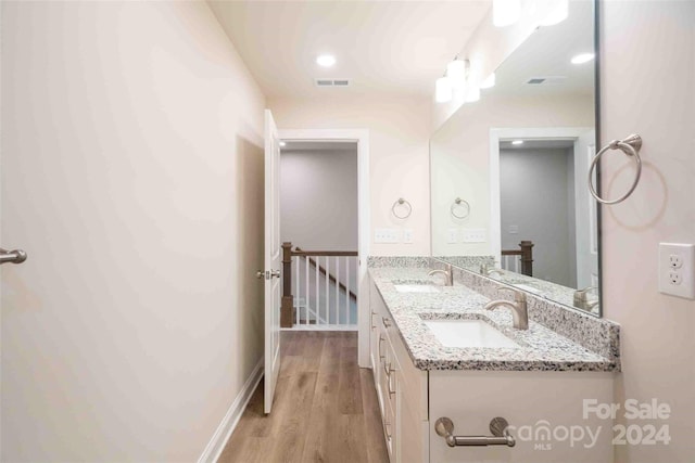 bathroom with hardwood / wood-style floors and vanity