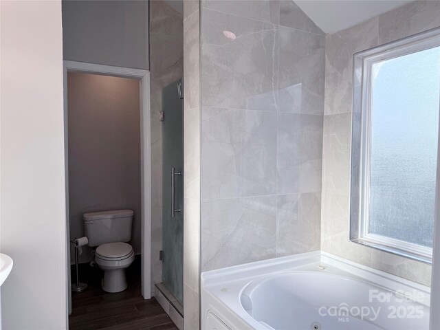 bathroom with wood-type flooring, separate shower and tub, toilet, and vaulted ceiling