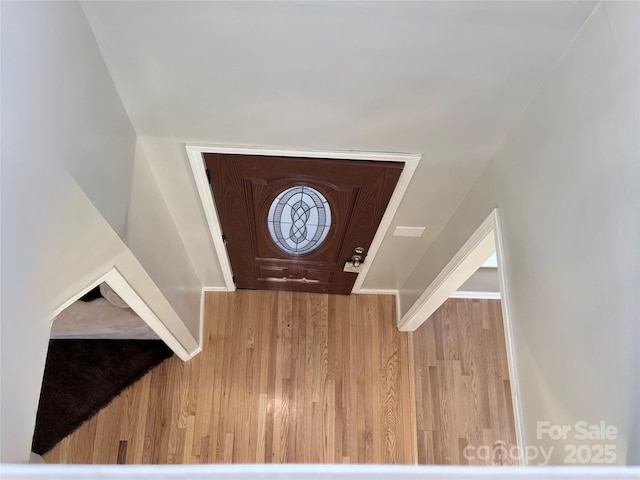 foyer entrance with wooden walls