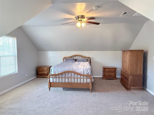 carpeted bedroom with ceiling fan and lofted ceiling