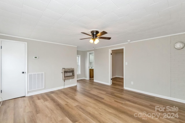 unfurnished room featuring heating unit, ceiling fan, light hardwood / wood-style flooring, and ornamental molding