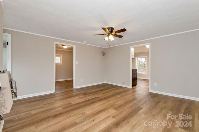 unfurnished room featuring ceiling fan, wood-type flooring, and crown molding