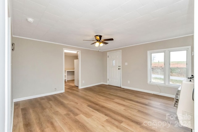 unfurnished living room with ceiling fan, crown molding, and light hardwood / wood-style floors