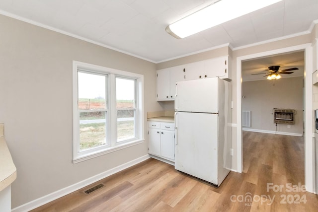 kitchen with light hardwood / wood-style floors, white fridge, white cabinetry, and heating unit