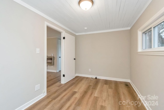 unfurnished room featuring light wood-type flooring, ornamental molding, wood ceiling, and heating unit