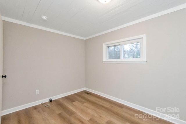 unfurnished room with light wood-type flooring and ornamental molding