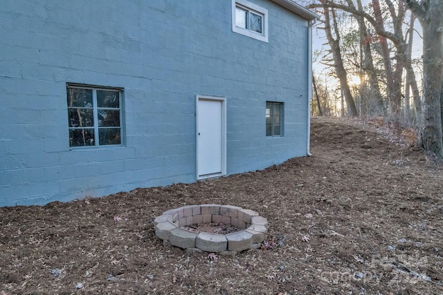 back of house with a fire pit