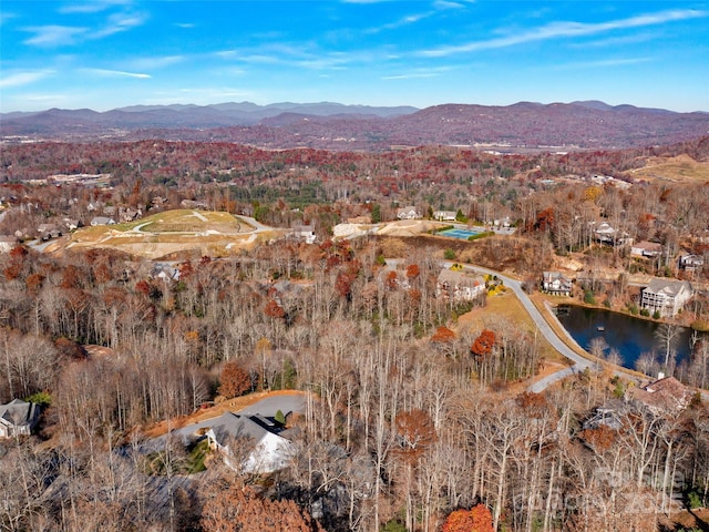 birds eye view of property with a water and mountain view