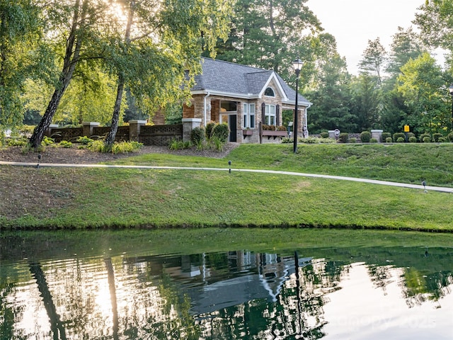 exterior space with a water view and a yard