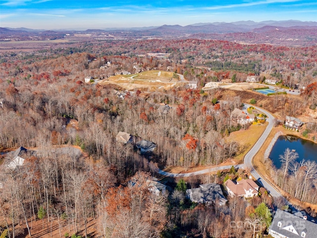 drone / aerial view featuring a water and mountain view