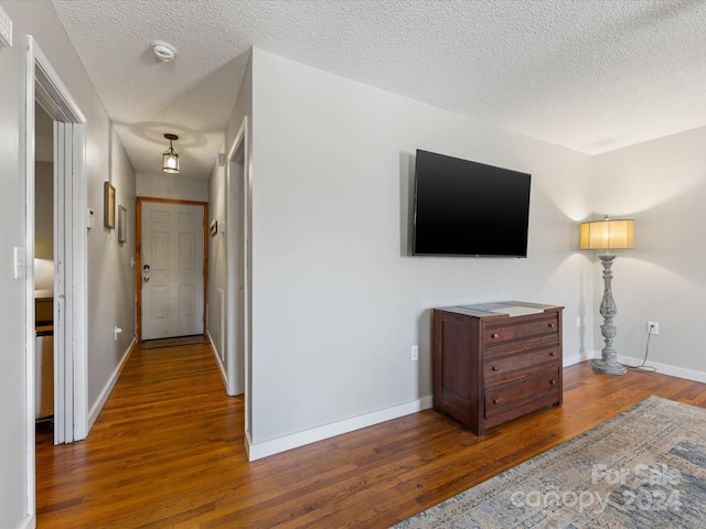 interior space featuring dark hardwood / wood-style floors and a textured ceiling