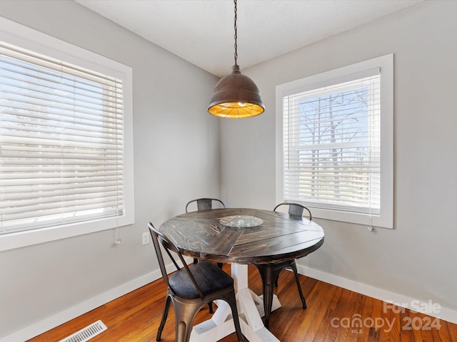 dining room with a wealth of natural light and hardwood / wood-style floors