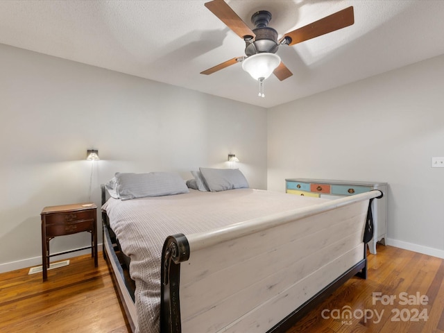 bedroom with ceiling fan and wood-type flooring