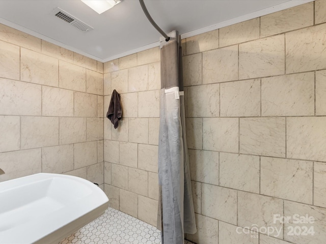 bathroom with a shower and crown molding