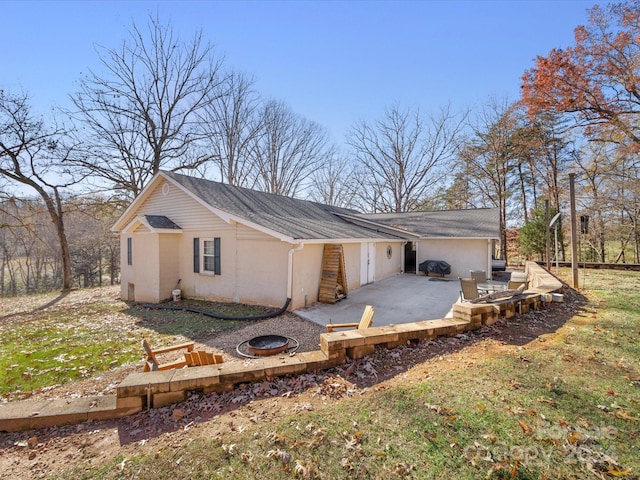 view of side of property with a yard and a patio area