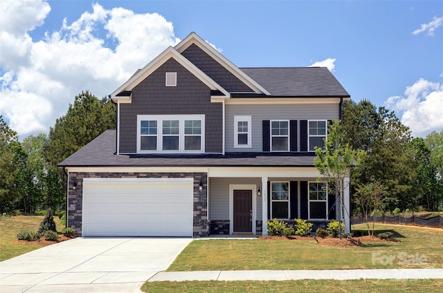 craftsman house featuring a front yard and a garage