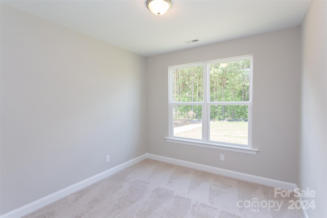 unfurnished room with light carpet