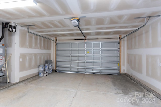 garage featuring gas water heater and a garage door opener