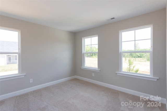 empty room featuring light carpet