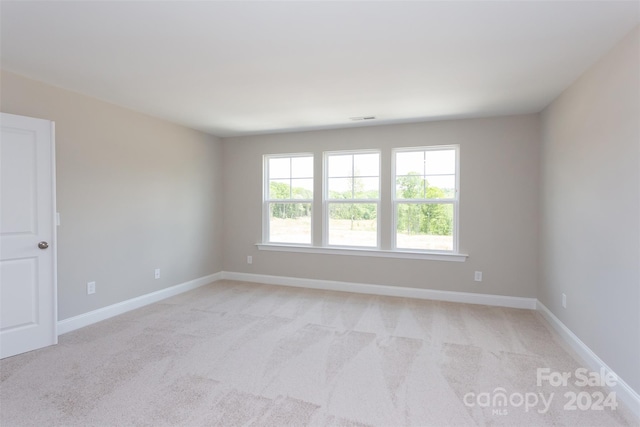 empty room featuring light carpet