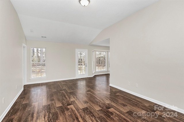 unfurnished room with dark hardwood / wood-style floors and lofted ceiling