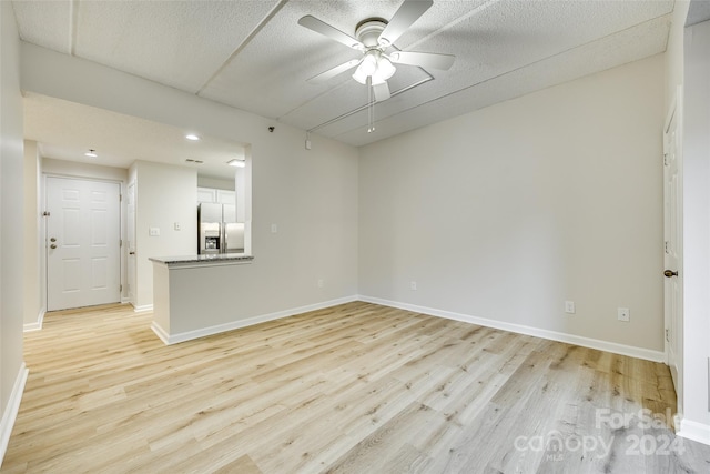 unfurnished room with light hardwood / wood-style floors and ceiling fan