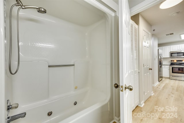 bathroom featuring shower / tub combination and hardwood / wood-style floors