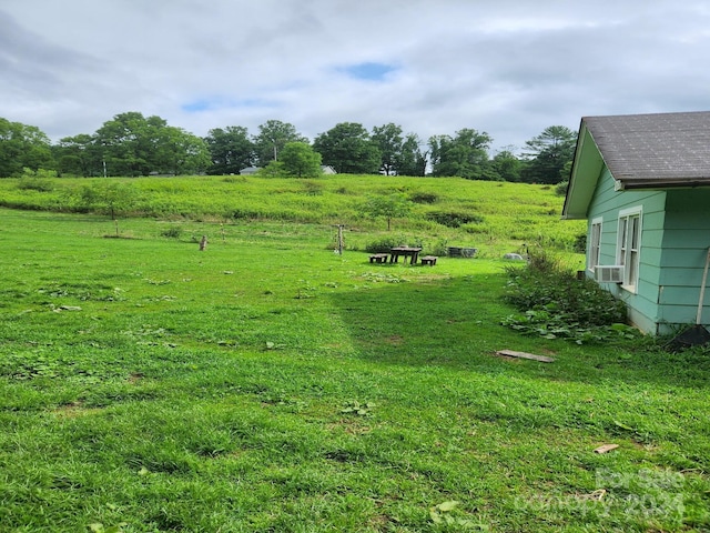 view of yard with cooling unit and a rural view