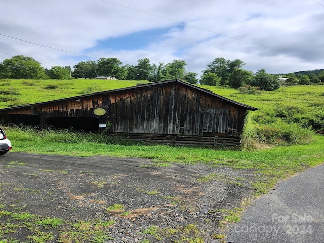 view of outdoor structure with a rural view