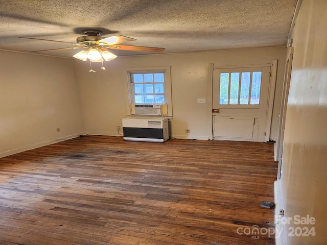 foyer with ceiling fan, cooling unit, dark hardwood / wood-style flooring, and a textured ceiling