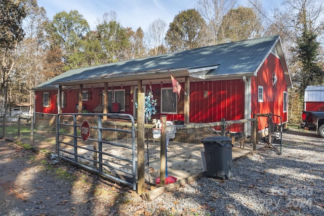 rear view of property featuring an outbuilding