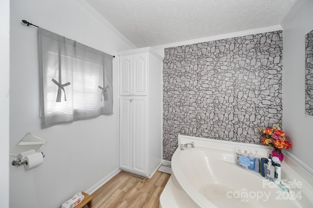 bathroom featuring crown molding, hardwood / wood-style floors, and tile walls