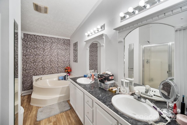 bathroom featuring a textured ceiling, vaulted ceiling, separate shower and tub, crown molding, and hardwood / wood-style floors