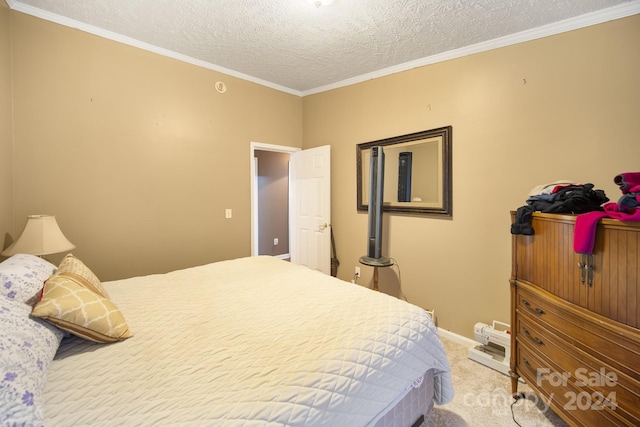 bedroom featuring carpet, a textured ceiling, and ornamental molding