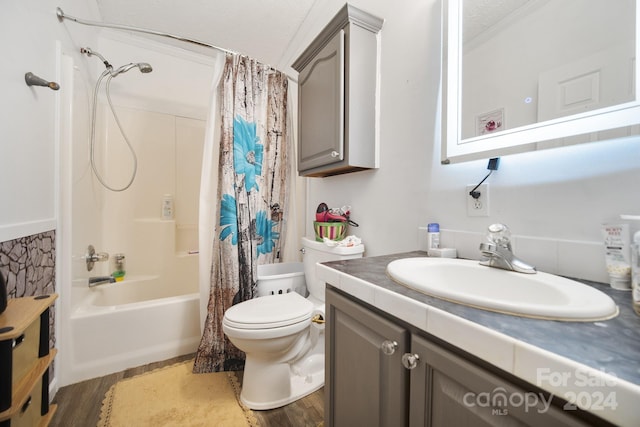 full bathroom featuring shower / bath combo, a textured ceiling, toilet, vanity, and hardwood / wood-style flooring