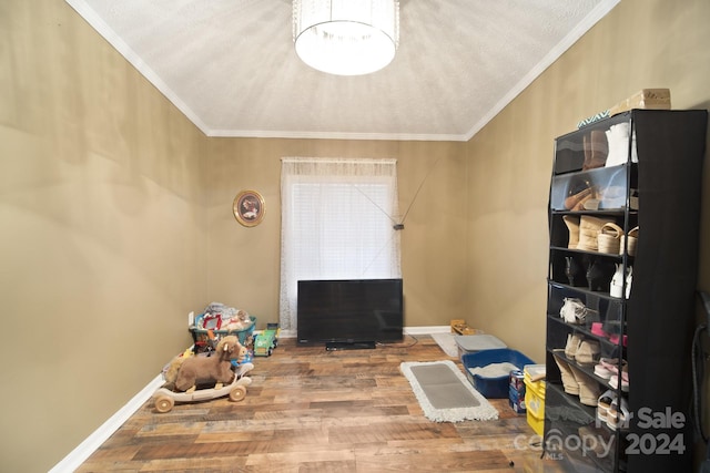 interior space featuring wood-type flooring and ornamental molding