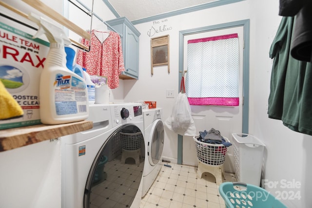 washroom with washing machine and dryer and cabinets