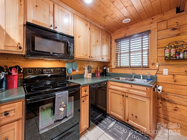 kitchen featuring sink, wooden ceiling, wooden walls, light tile patterned flooring, and black appliances