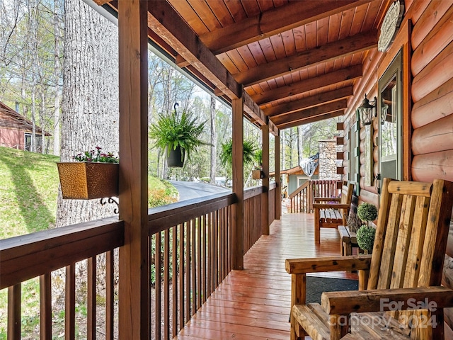 wooden terrace featuring covered porch